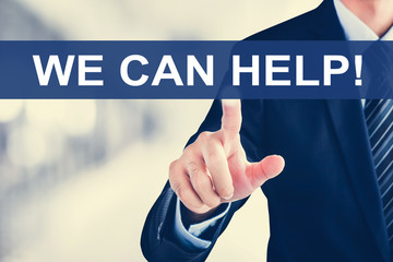 Businessman hand touching WE CAN HELP ! tab on virtual screen