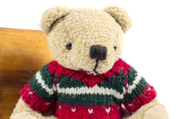 Teddy bear with wool coat, on white