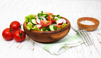 Spring salad with tomato, cucumbers and radish