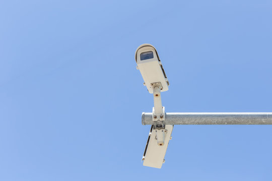 Two security camera on blue sky