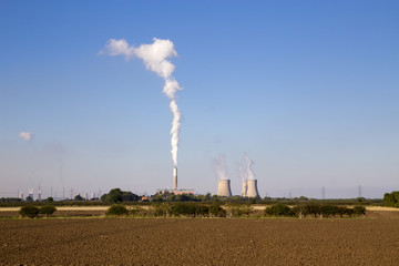 Stock photograph of Cottam power station with steam / smoke emmissions rising into the sky from the cooling towers.  West Burton power station visible in the distance.