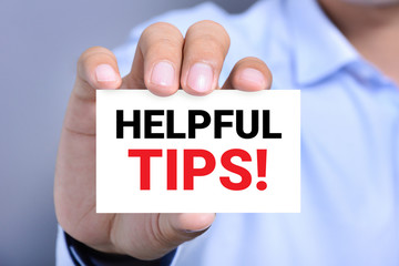 HELPFUL TIPS! message on the card held by a man hand