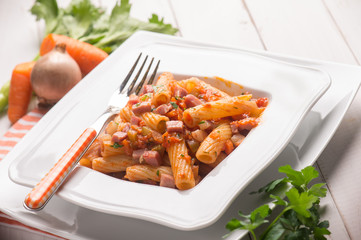 pasta with tomatoes sauce and bacon, selective focus