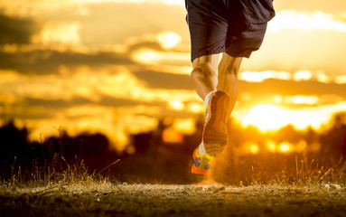 sport man strong legs in off road trail running at amazing summer sunset healthy lifestyle
