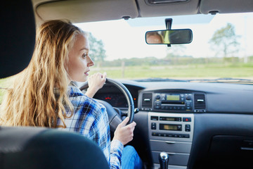 Fototapeta na wymiar Young confident woman driving a car