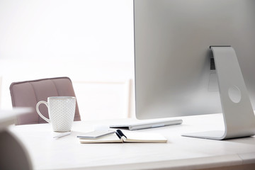 Workplace with computer in room