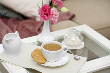 Cup of coffee on table in living room