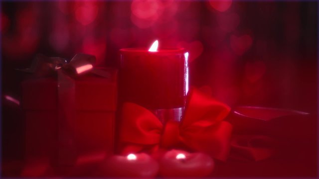 Love concept. Beautiful Valentine scene with red hearts candles on holiday table