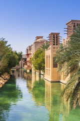 Scenic boat on green water canals in the city of Dubai.