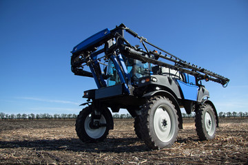 Fototapeta na wymiar Blue tractor care harvest