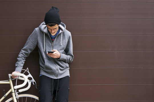 Man With Mobile Phone And Bicycle