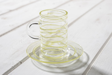 Slim Crystal Mug and Saucer Yellow Streaks on Wooden Panel