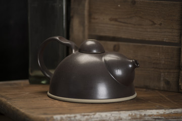 Black Teapot with Lid on Wooden Counter