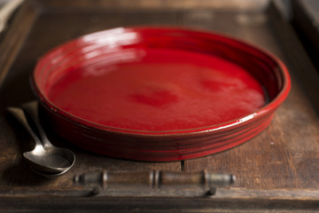 Red Round Shallow Serving Dish and Spoons in Wooden Tray