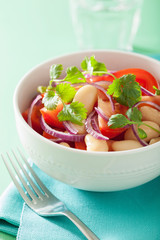 healthy tomato salad with white beans onion cilantro