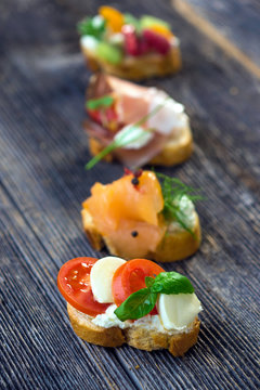 Delicious tapas on a wooden background