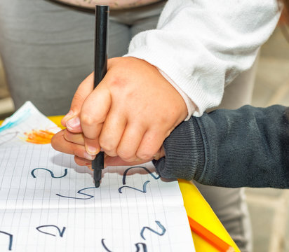 Children hands writing together
