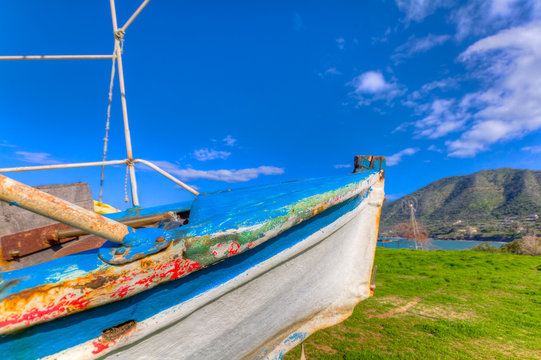 Abandoned Fishing Boat out of sea in afternoon light in  Pomos, Cyprus