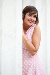 Fototapeta premium Portrait of smiling girl in urban background