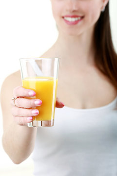 head and shoulders portrait of attractive caucasian smiling woman isolated on white studio shot drinking orange juice face skin