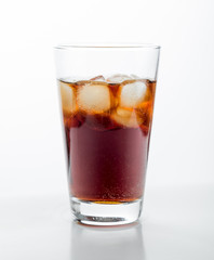 Cola glass with ice cubes on a white background