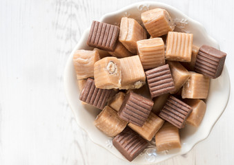 variety of caramel bonbons in the bowl,blank space
