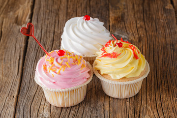 Colored cupcake on rustic background