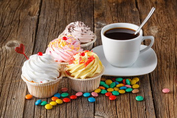 Colored cupcake on rustic background
