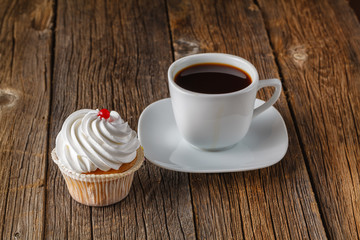 Colored cupcake on rustic background