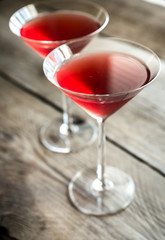 Two cosmopolitan cocktails on the wooden background