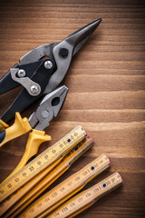 Composition of tin snips pliers wooden meter construction concep