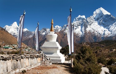 White stupa, prayer flags and himalayas