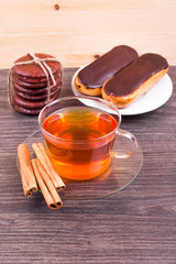 Tea, eclairs and cinnamon on a table