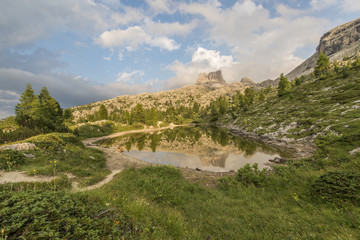 Fascinating reflections of the Dolomites mountains in lake Limed
