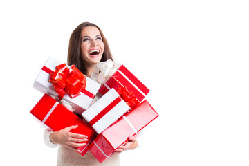 Joyful woman woman holding a lot of boxes with gifts on a white background.
