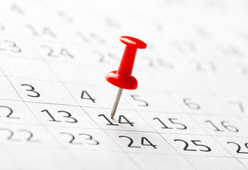 Concept image of a calendar with red push pins