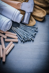 wooden dowels nails blueprints hammer gloves