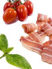 fresh snack of dry smoked ham tomato and basil isolated on white