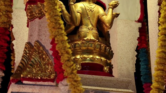 Golden statue of deity on the street in Pattaya, Thailand