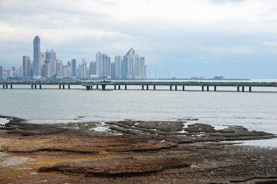 Highway over the ocean and Panama city skyscrapers