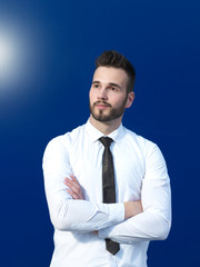 Businessman in front of blue background smiling