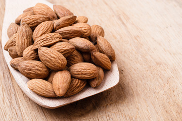 Almonds on wooden spoon