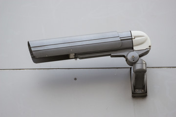 Security camera on the gray wall.