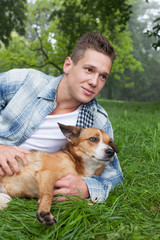 young man cuddeling with his dog