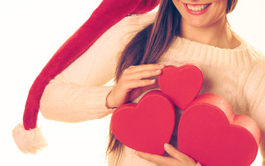 Girl holds heart shaped gift boxes