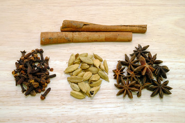 Various spices on a wooden background.