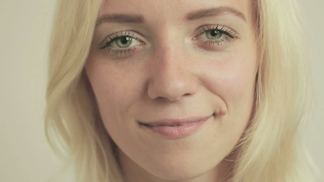 Smiling young girl with braces on teeth looking at camera 