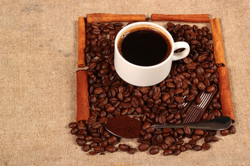 Coffee beans and teaspoon of ground coffee with chocolate bars a