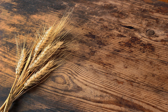 Ears of wheat on wooden table