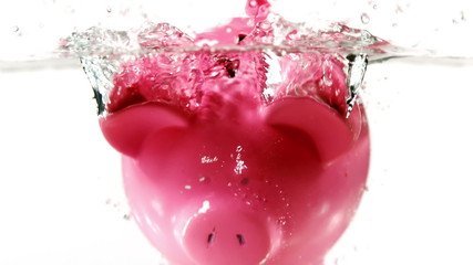 Piggy bank falling into water - Powered by Adobe